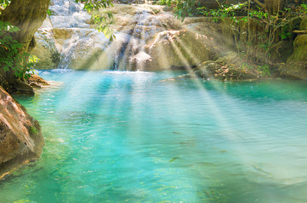 Tropical waterfall with emerald lake in jungle forest, a Nature Photo by Vapi