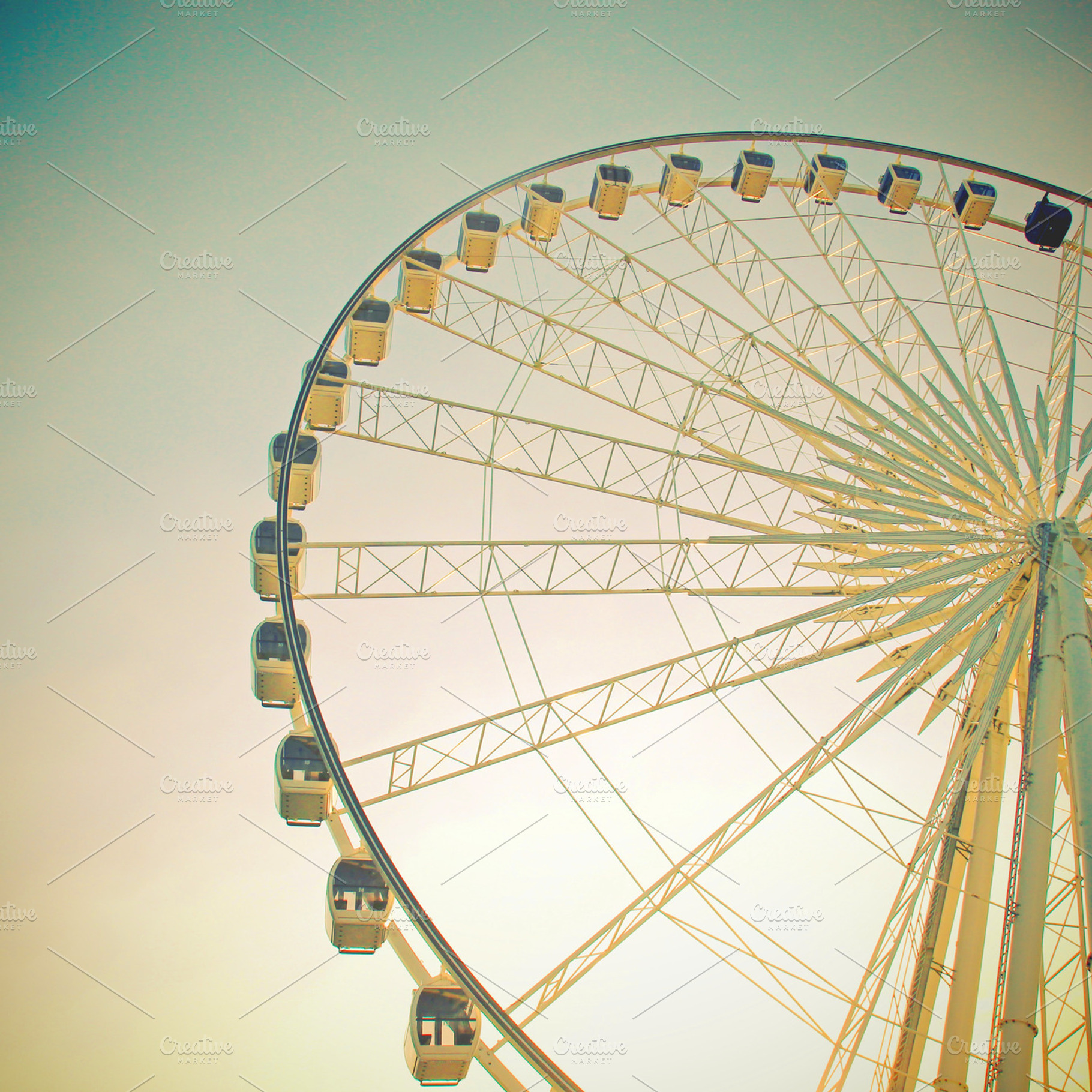 Ferris wheel with blue sky containing ferris wheel, sky, and retro