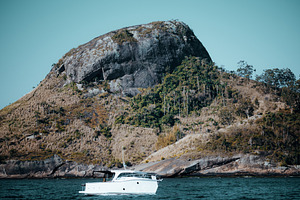 Luxurious yacht near tropical island, a Wallpaper Photo by SkyNext
