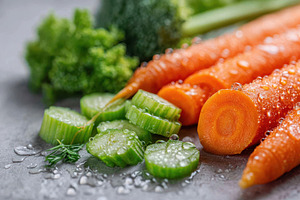 Fresh carrots and cucumber slices with water droplets, a Food & Drink Photo by AlyaAnd