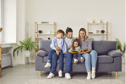 Young happy family reading a book to, a Person Photo by StudioRomantic