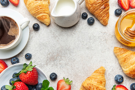 Continental breakfast composition with croissants, coffee, berri