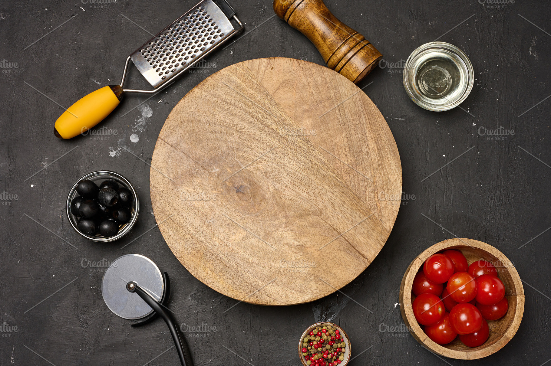 A round empty wooden board on a dark background with tomatoes, o, a Food & Drink Photo by ndanko