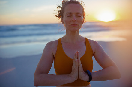relaxed healthy woman jogger in fitness clothes meditating, a Sports & Recreation Photo by Alliance Images
