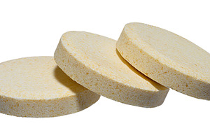 Stack of large round pills of light yellow color, isolated backg, a Health & Medical Photo by ndanko