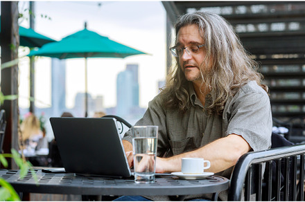 Man working with laptop in the table, a Business Photo by Ungvar Studio