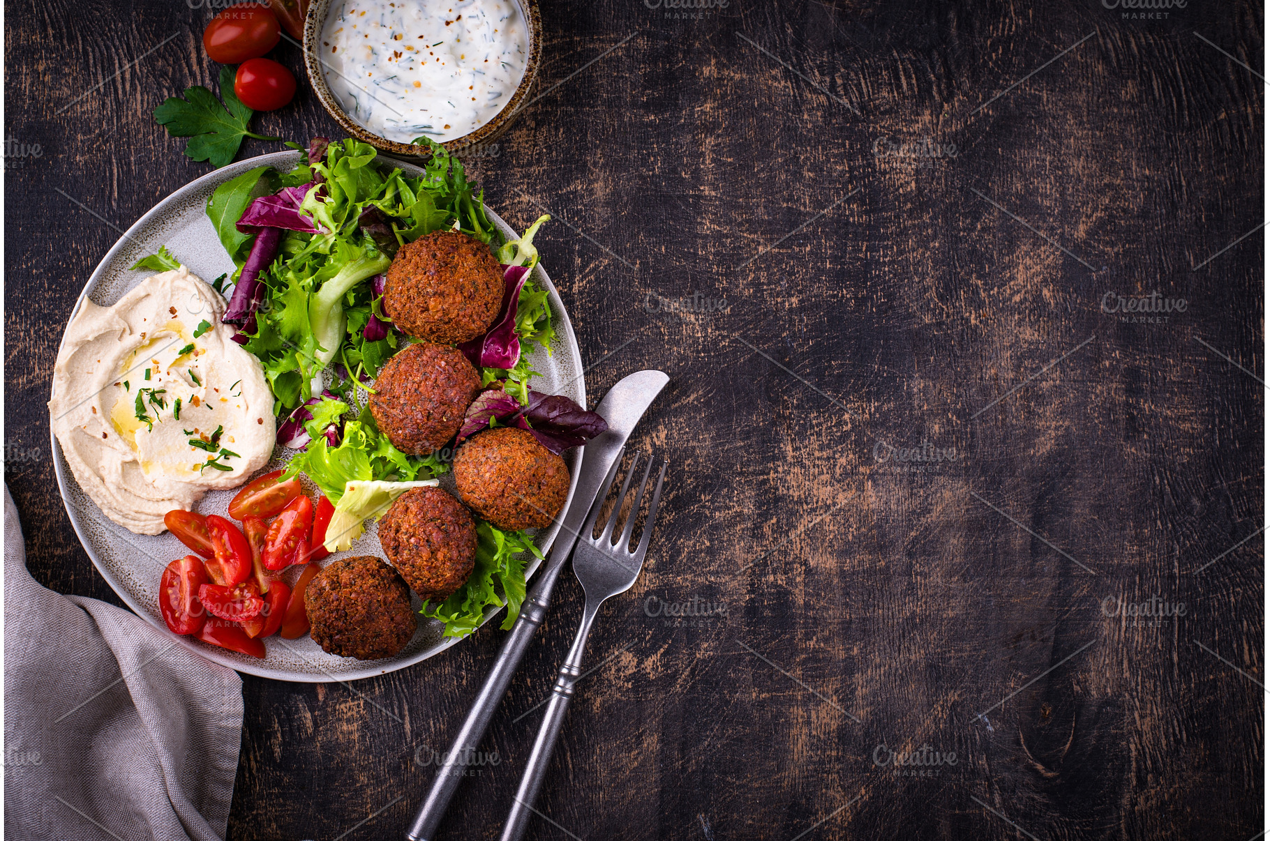 Salad with hummus, falafel and, a Food & Drink Photo by Yulia Furman