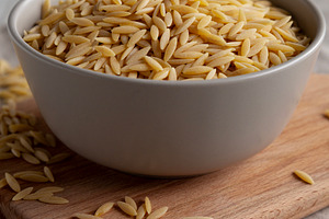 Organic Dried Orzo Pasta in a Bowl, side view. Close-up., a Food & Drink Photo by LiudmylaChuhunova
