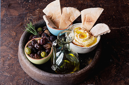 Middle east meze hummus featuring hummus, pita, and bread, a Food & Drink Photo by sebastianaraw