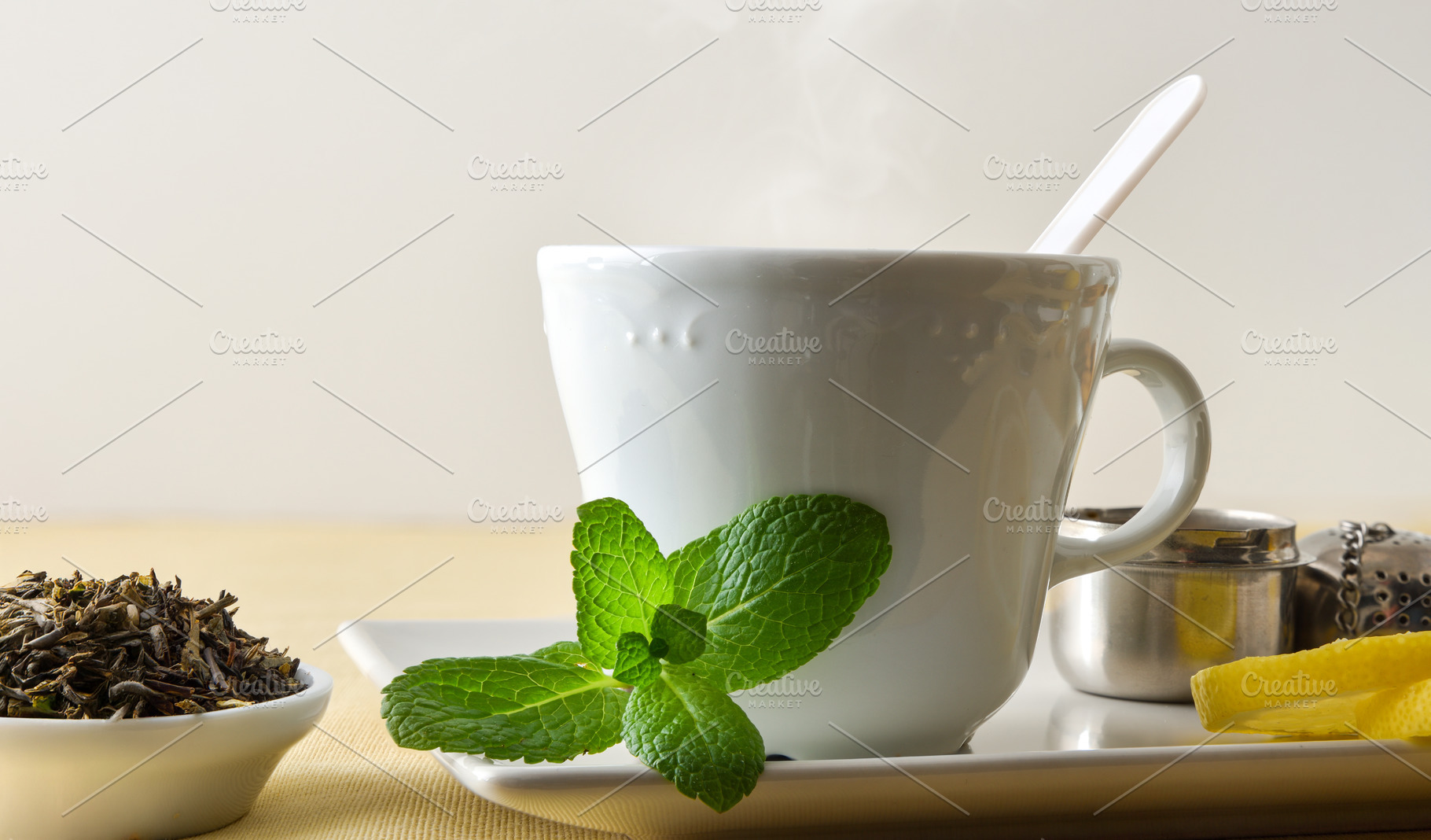 Macro teacup with mint and lemon white isolated background, a Food & Drink Photo by Davizro's Market