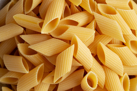 Raw Organic Dry Pennoni Pasta in a Bowl, top view. Close-up., a Food & Drink Photo by LiudmylaChuhunova