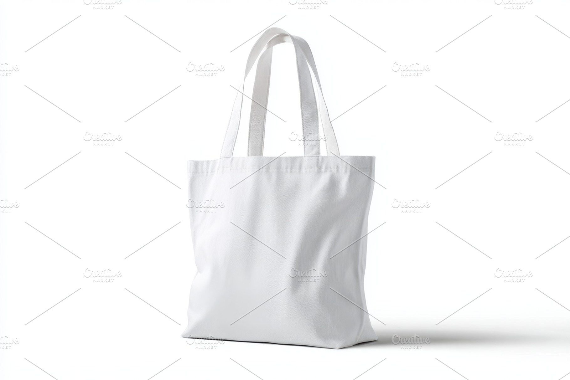 Plain white tote bag on white background, an Abstract Photo by AlyaAnd
