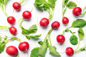 Fresh red radishes with green leaves on white background, a Food & Drink Photo by Olena Rudo