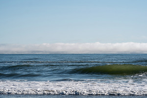 Rolling ocean waves with fog bank, a Photo by Elena Vagengeim