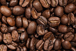 Whole roasted coffee beans scattered chaotically, a Food & Drink Photo by ndanko