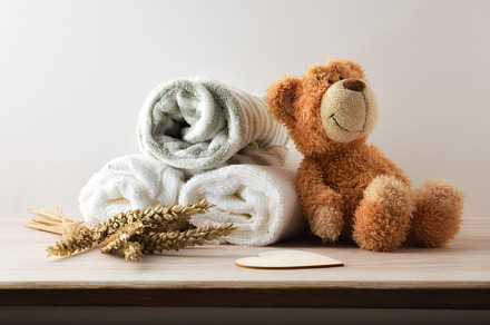 Child's bedding on wooden table with teddy isolated background, a Health & Medical Photo by Davizro's Market