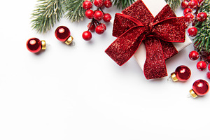 Christmas gift box with festive red decorations on white, a Holiday Photo by Olena Rudo