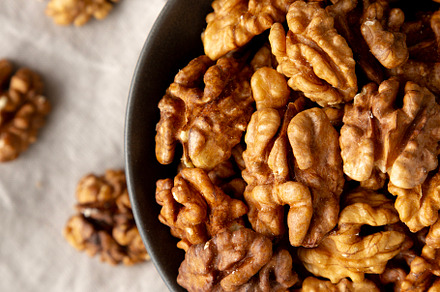 Raw Walnut Halfs in a Bowl, top view. Flat lay, overhead. Close-