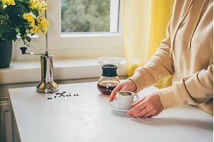 Unrecognisable woman holding cup of