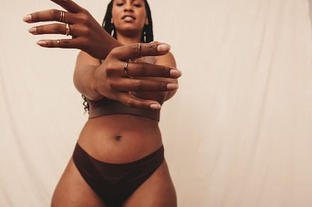 Young woman extending her hands towards the camera in a studio, a Person Photo by Jacob Lund