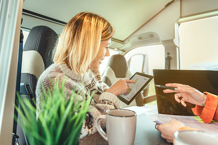 Women telecommuting in a camper van, a Person Photo by davidpereiras