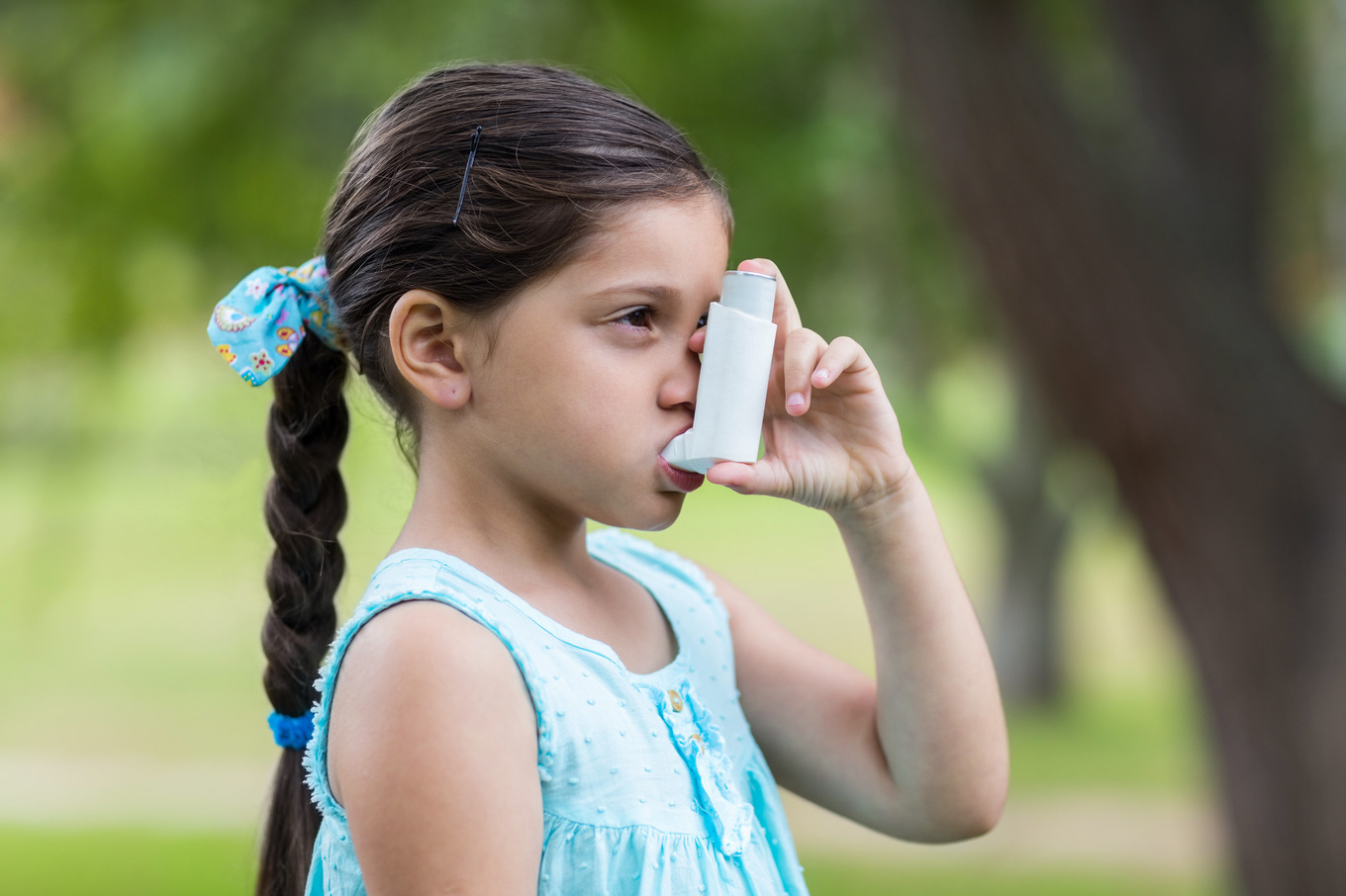 Little girl using his inhaler, a Photo by wavebreak | Creative Market