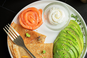 Roasted thin pancakes with smoked salmon and sauce, a Food & Drink Photo by Budarinphoto