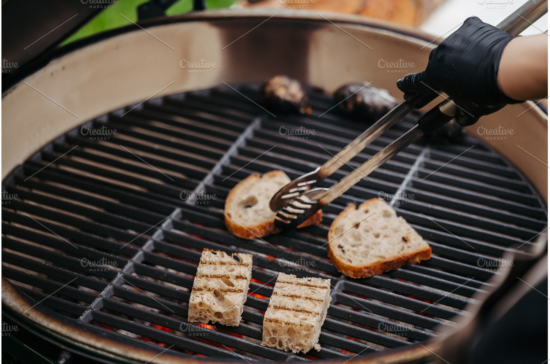Grilling slices of rustic bread on, a Food & Drink Photo by HalfPoint