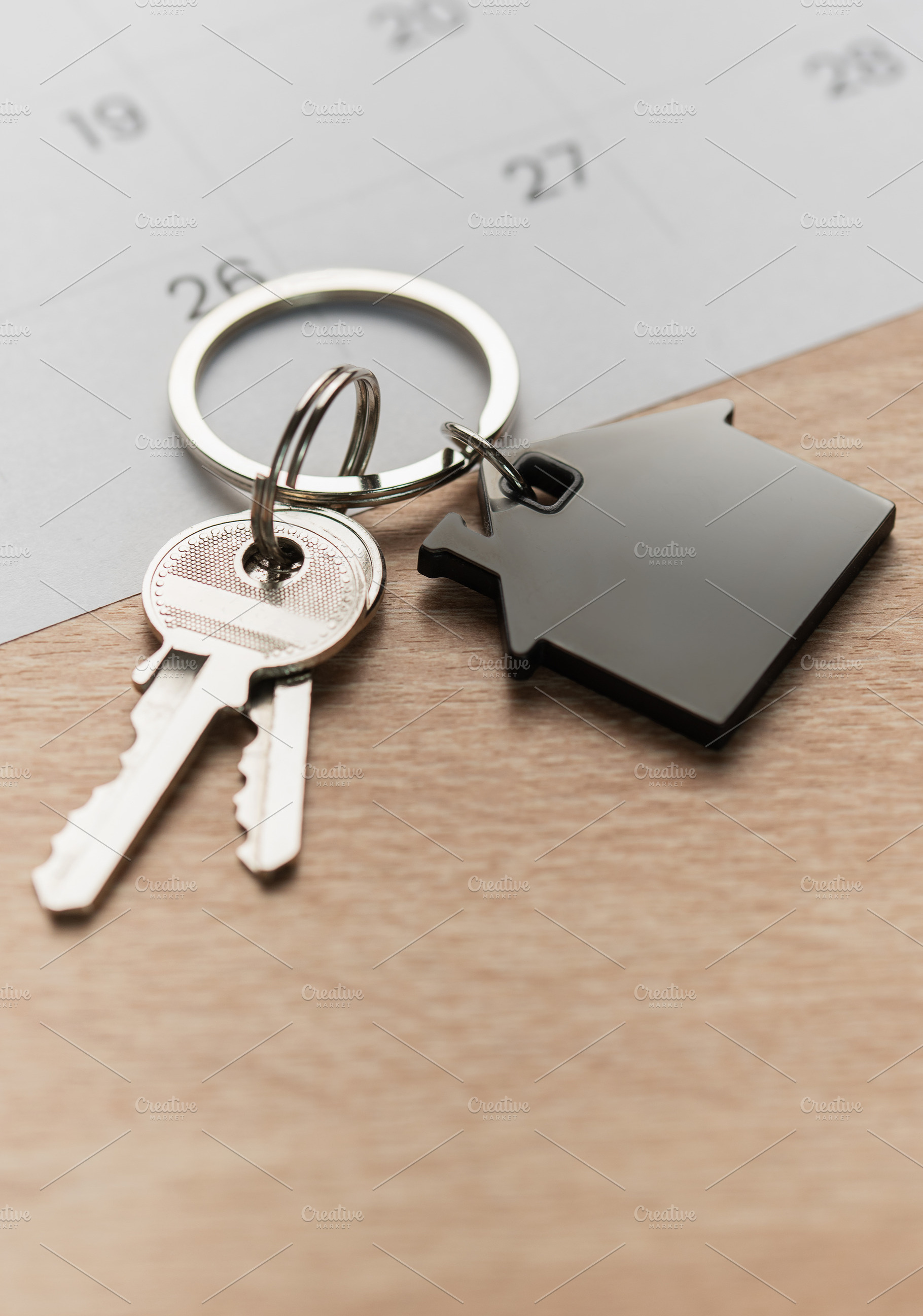 House keys with calendar background indicating moving day, a Business Photo by Olena Rudo