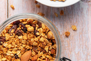 Granola cereal in glass jar, healthy breakfast concept, a Food & Drink Photo by Olena Rudo