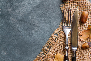 Thanksgiving autumn place setting containing dinner, decoration, and cutlery