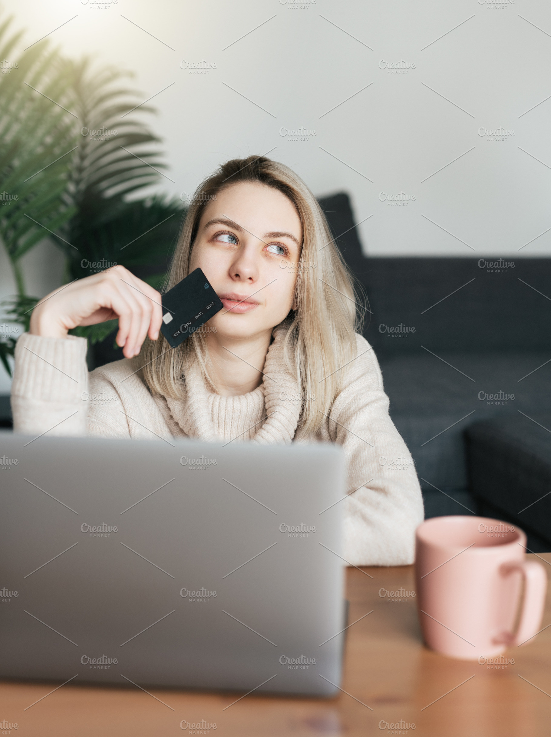 Young woman holding credit card and using laptop computer., a Business Photo by Olena Rudo