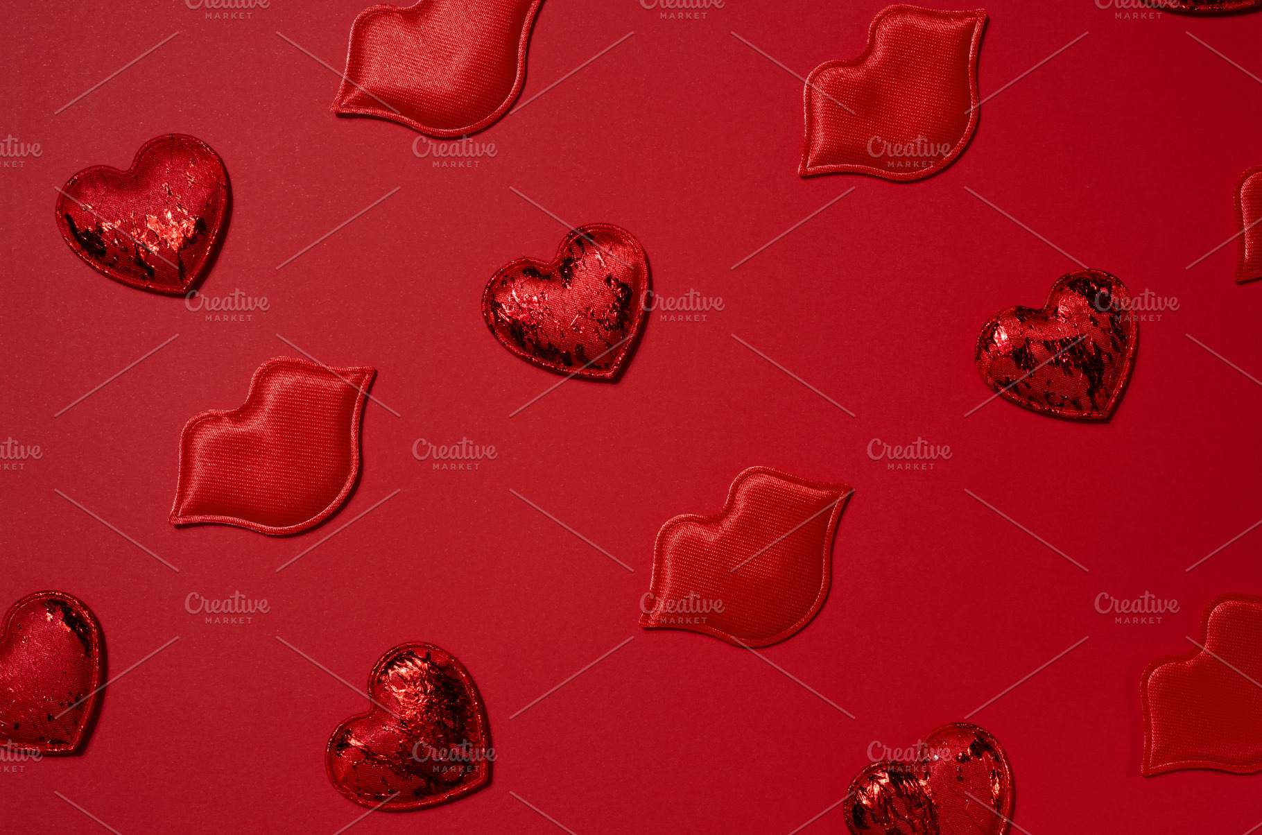 Red decorative hearts and lips randomly placed on a bright red b, a Holiday Photo by ndanko