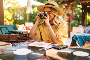 Young woman captures memories using a classic film camera surrou, a Person Photo by DanFLCreativo
