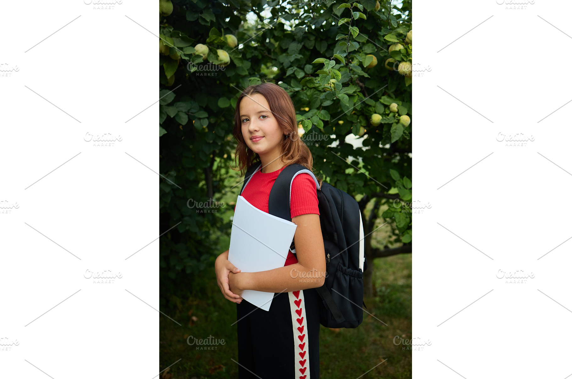 Teenage girl stands outside holding, a Nature Photo by IlliaBondarPhotography