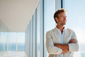 Confident man by ocean view window, a Business Photo by AlyaAnd