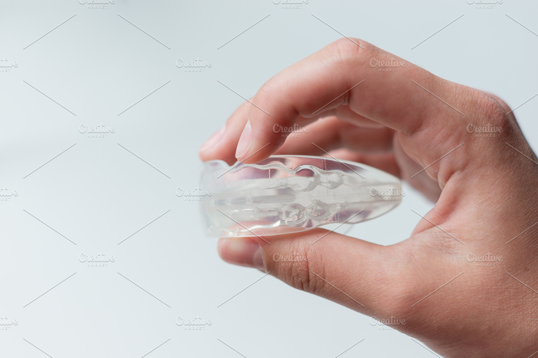 Holds a mouth guard in his hand, a Health & Medical Photo by Nastya_Velko