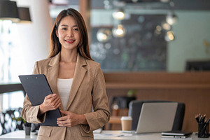Young Businesswoman Holding Clipboard in Modern Office, a Business Photo by Davizro's Market