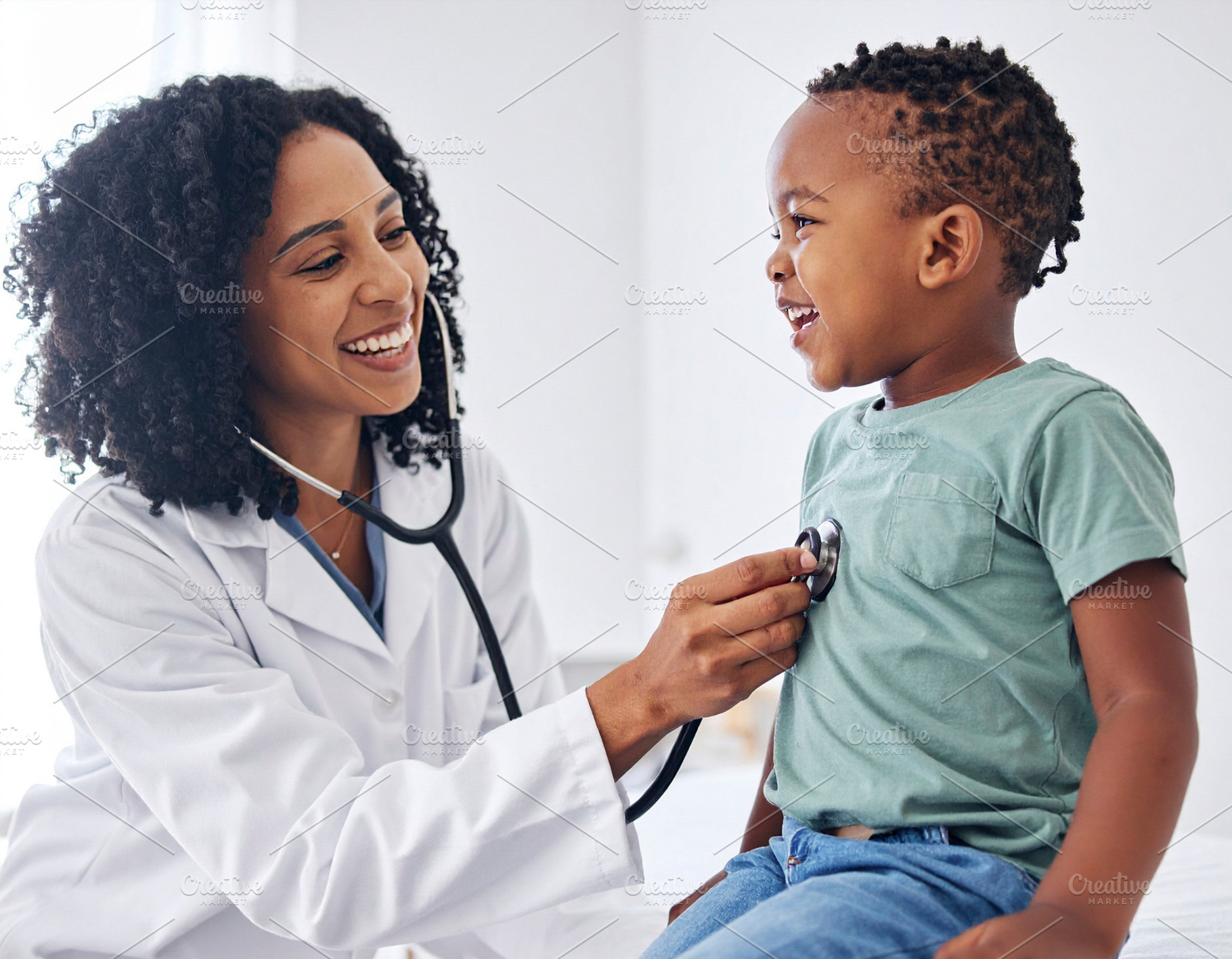 Pediatrician examining a cheerful child with a stethoscope in a, a Health & Medical Photo by DanFLCreativo