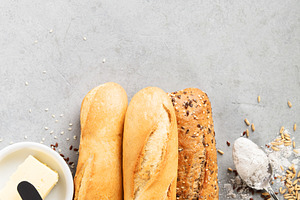 Assorted Baguettes with Butter, Flour, and Seeds on Table, a Food & Drink Photo by Natalia Klenova's Shop