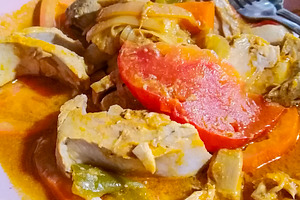 Fish stew with tomato and vegetables on pink plate, a Food & Drink Photo by DanFLCreativo