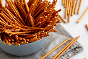 Organic Salty Pretzel Sticks in a Bowl, side view., a Food & Drink Photo by LiudmylaChuhunova