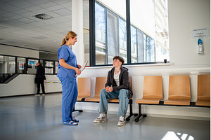 Doctor talking with teenage patient, a Person Photo by HalfPoint