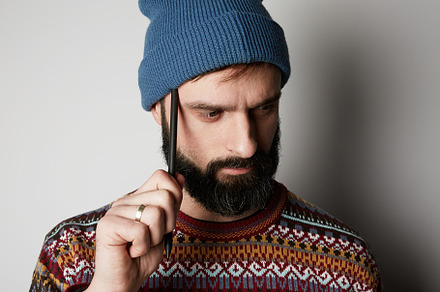 Young thoughtful bearded man in blue stock photo containing man and male