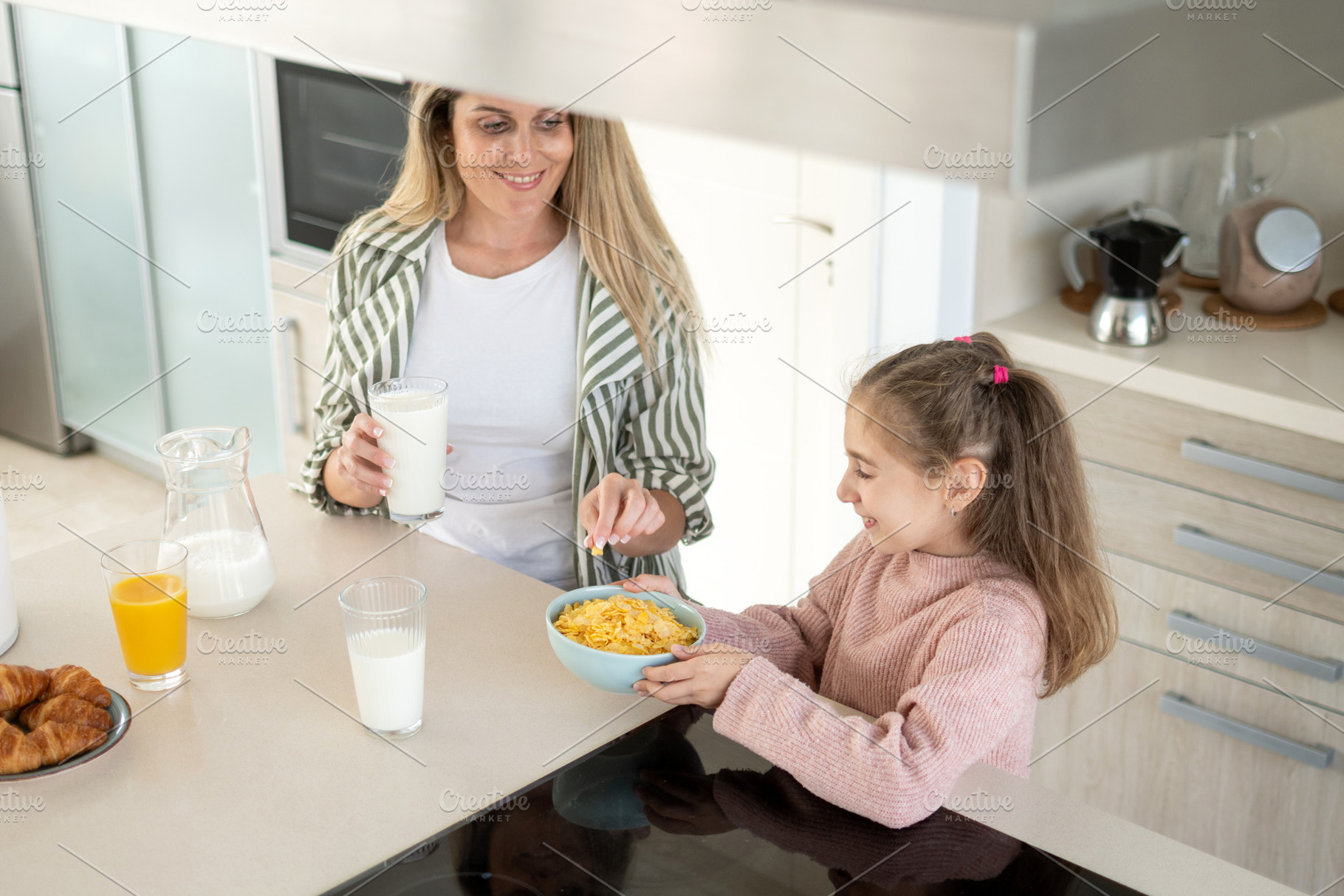 Mother and daughter enjoying healthy breakfast together, a Person Photo by etorres69