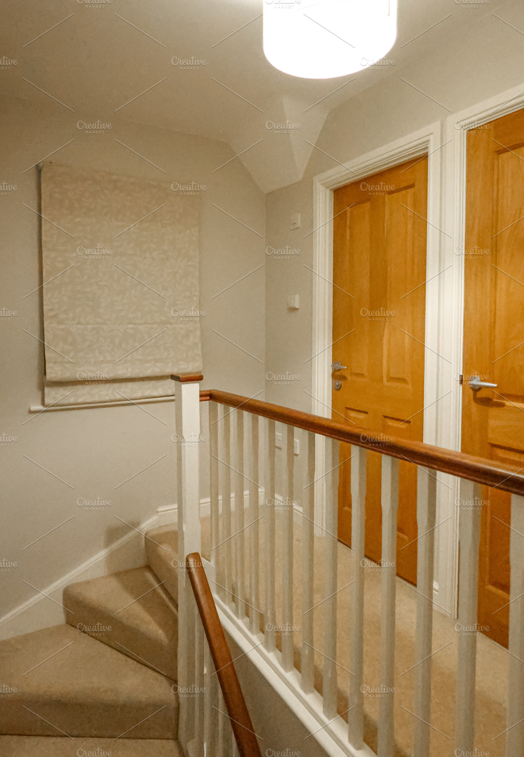 Modern home interior with carpeted stairs, wooden railing, and n, a Photo by Studio ANNA