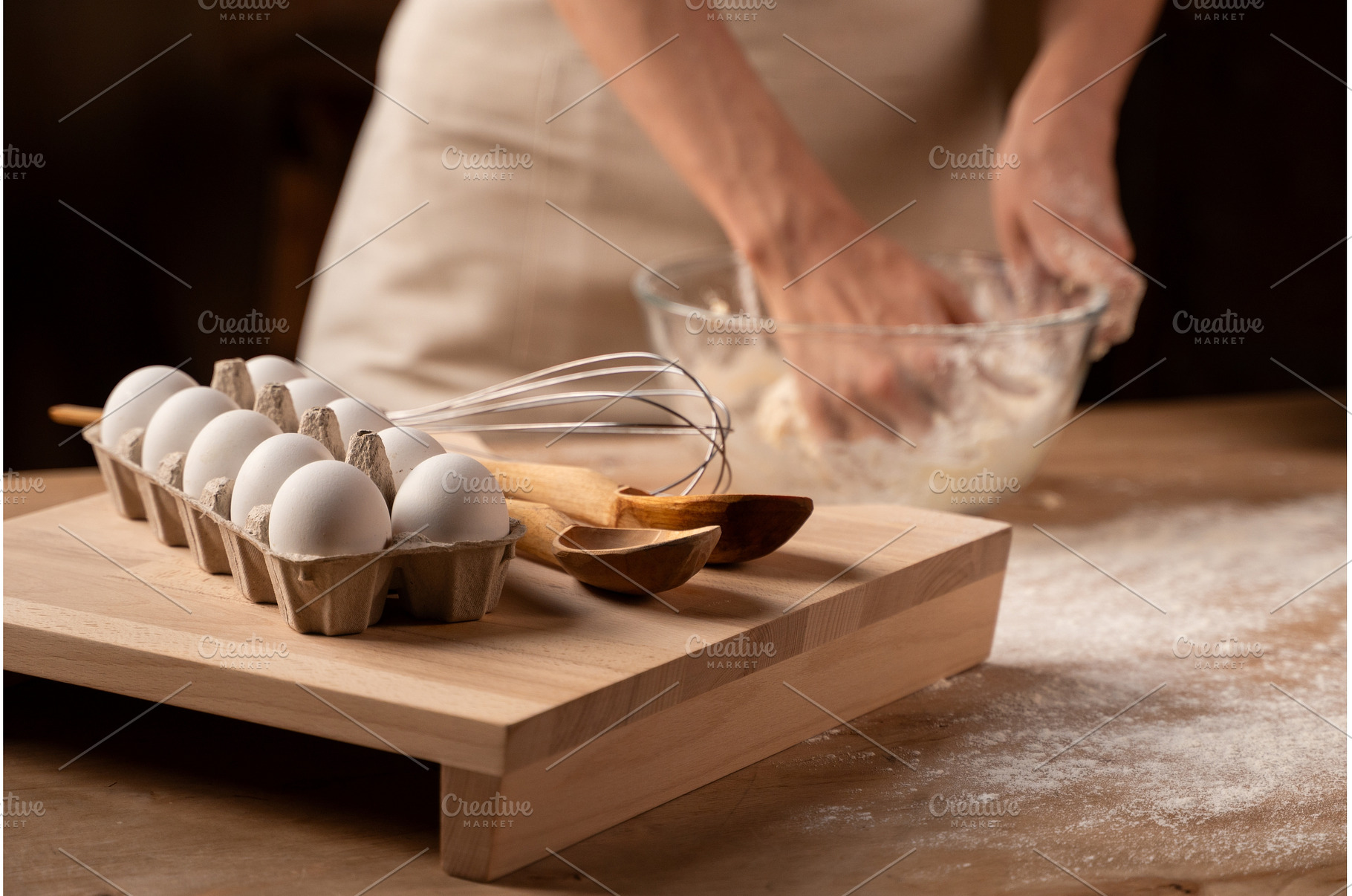 Hands kneading dough in a glass bowl, a Food & Drink Photo by volodymyrshtun13795