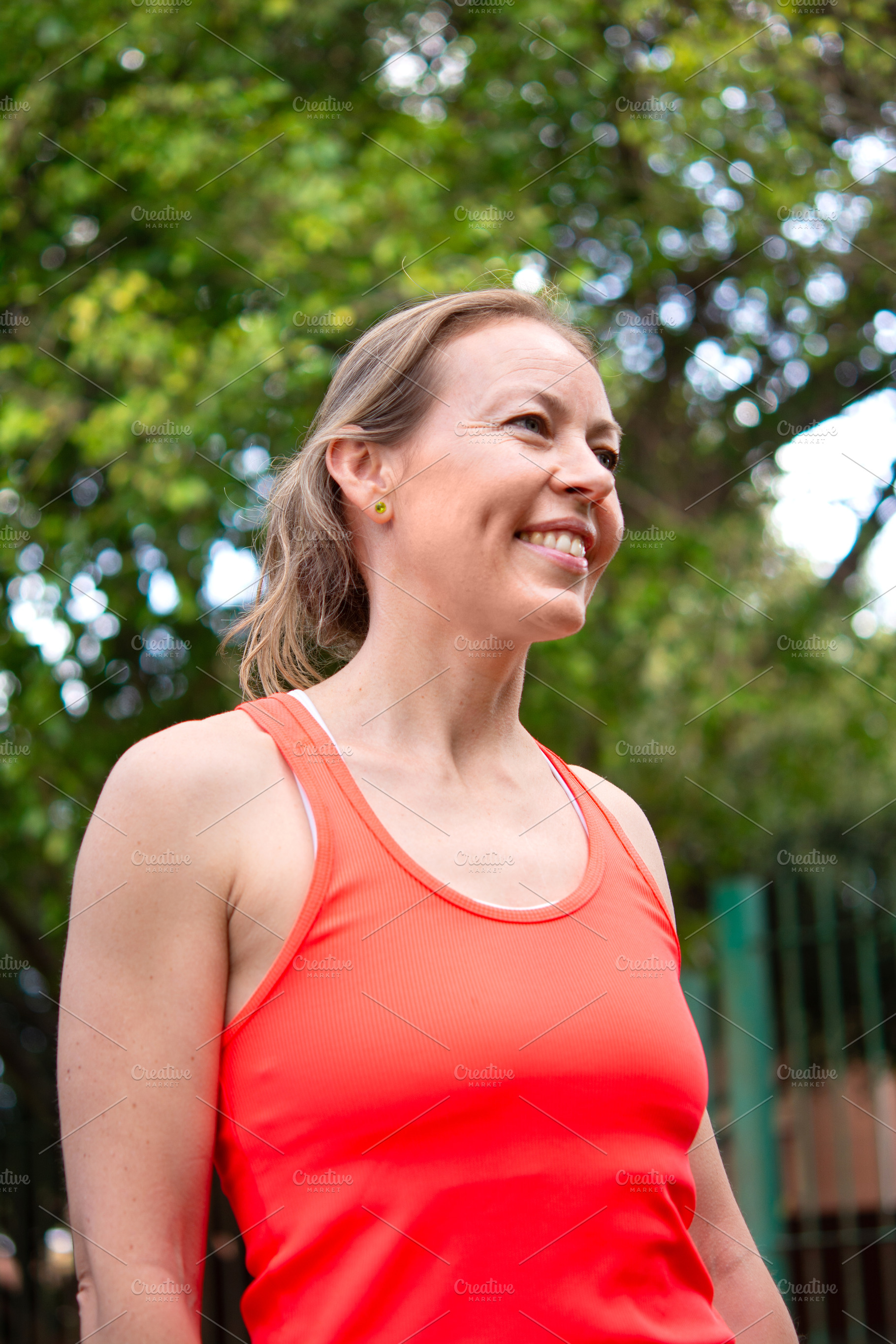 Smiling mature woman enjoying outdoor fitness activity in park, a Person Photo by etorres69