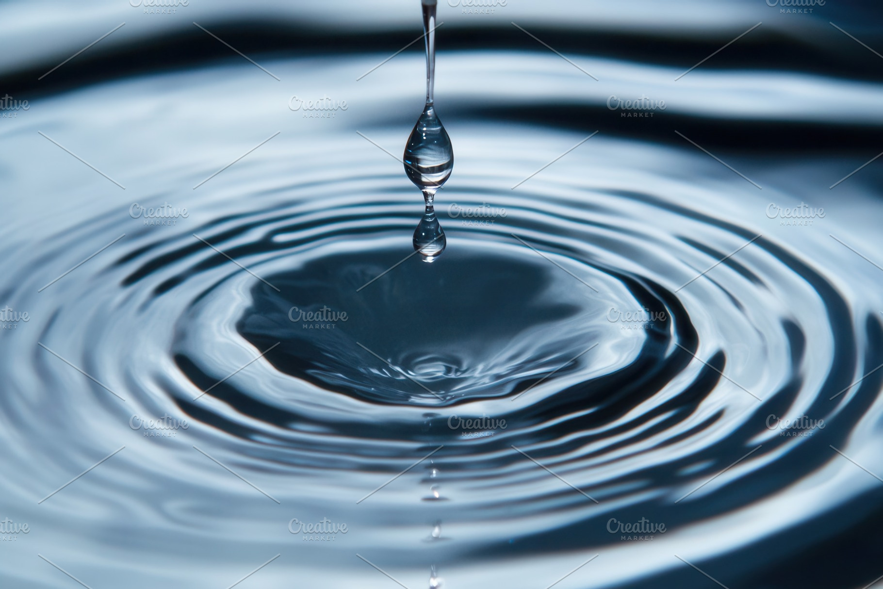 Droplet creates ripples of calm, a Photo by Pavel_design