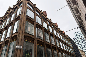 Perspective view of a historic brownstone building with large gl